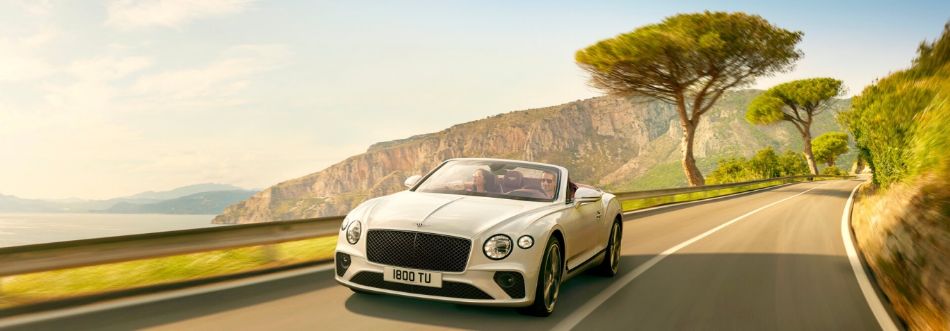 1573348162466249.jpg new white Bentley Continental GT Convertible driving by cliffs and sea in Italy 1920x670.jpg